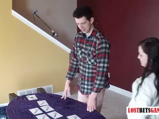 A girl and a guy play a game of strip match the cards
