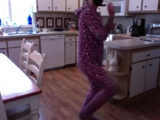Felicity Feline dancing and being a weirdo in a onesie and green face mask