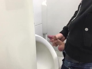 Gay boy is jerking off in public restroom and shoot his load in a urinoir