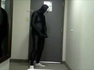 skeleton faced white socked black morphman in front of hotel room