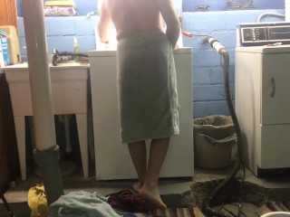 Naked man doing laundry