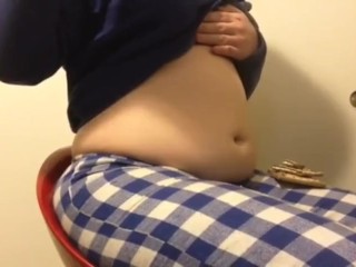 Chubby girl stuffs belly with junk food