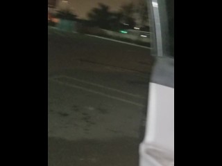 Cumming in public in a parking lot outside