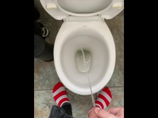 Pissing at home in red and white socks