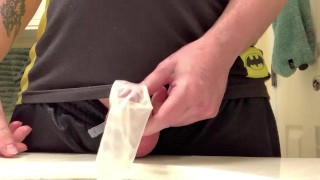 Hard cock pissing in a condom